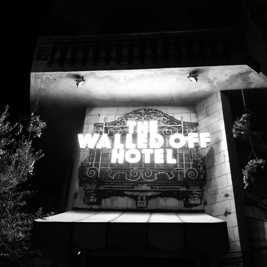 A black and white image of the Walled Off Hotel in Bethlehem, on the West Bank.