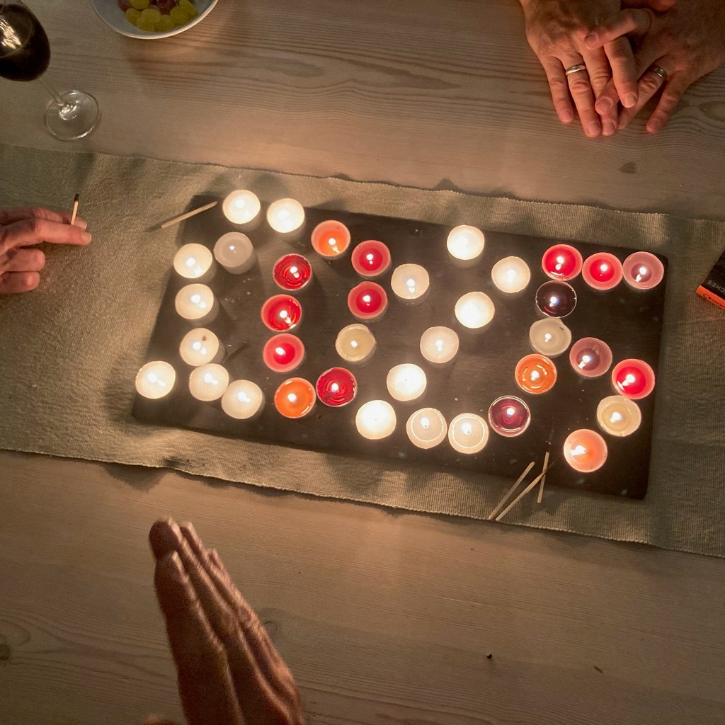 Coloured tealights spelling out the legend 2025